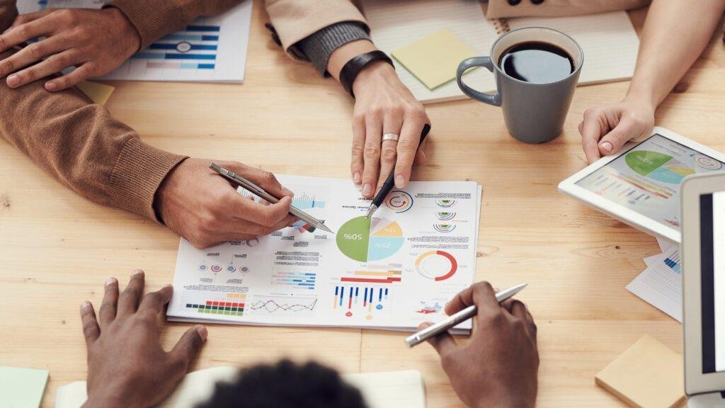 3 people around a table looking at a chart