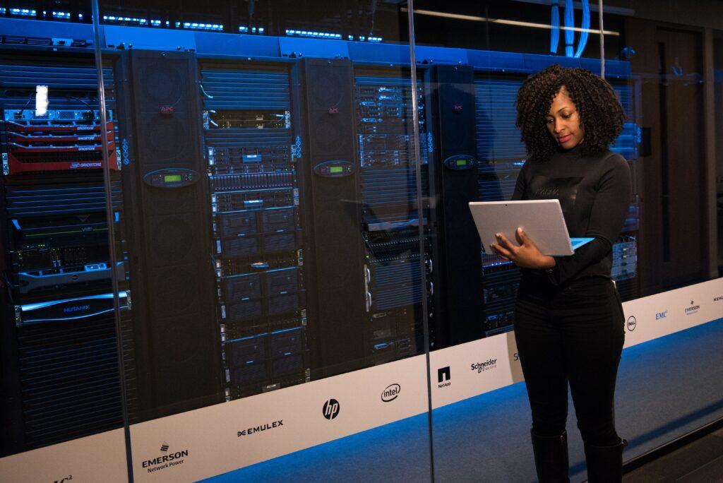 A woman in front of data screens