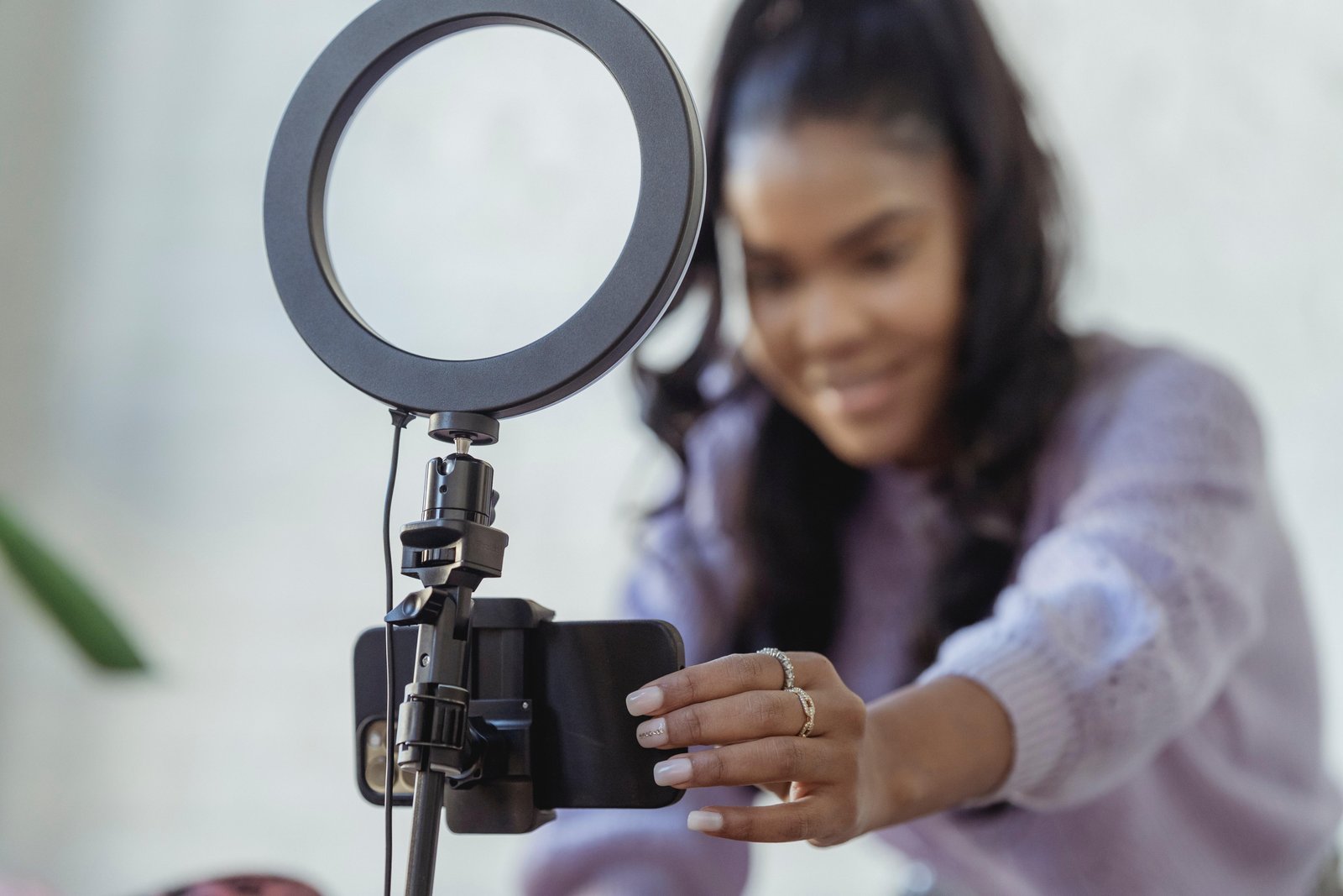 a woman with a phone and ringlight